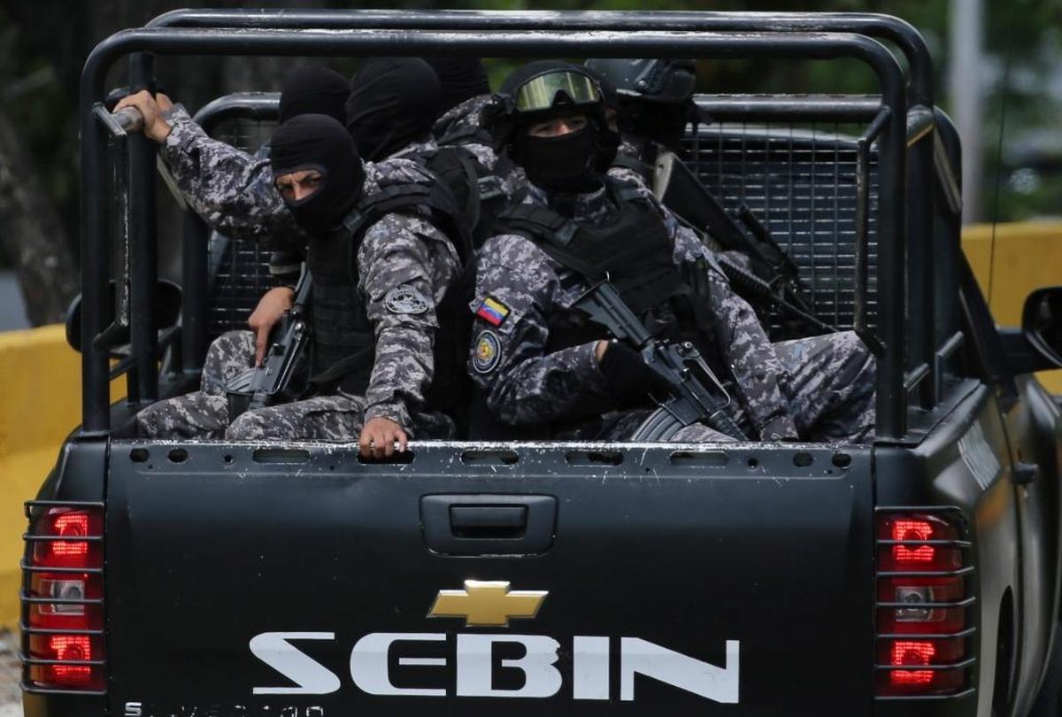 Members of the Venezuelan Bolivarian Intelligence Service arrive at the Junquito highway during an operation to capture Oscar Perez in Caracas, Venezuela.