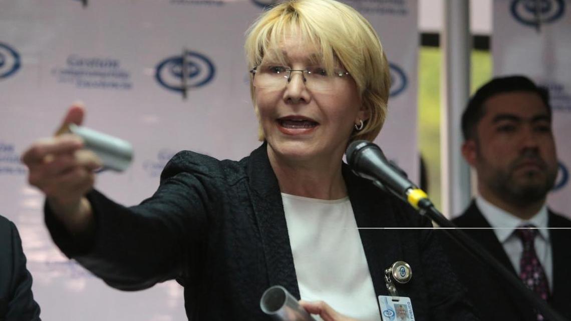 Venezuela's Chief Prosecutor Luisa Ortega Diaz holds up the kind of tear gas canister used by security forces to disperse anti-government protests, as she speaks to the press at her office in Caracas, Venezuela, Wednesday, May 24, 2017.