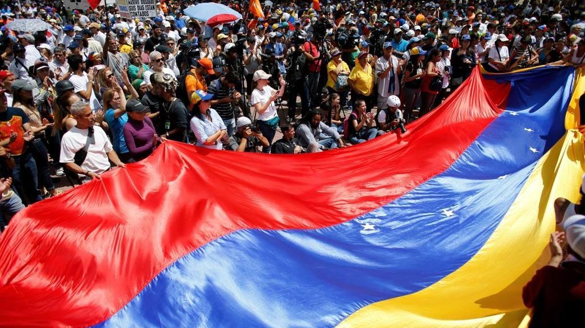 Anti-government demonstrators wave a Venezuelan flag during a protest against Venezuela's President Nicolás Maduro in Caracas, Venezuela, Saturday, Aug. 12, 2017.