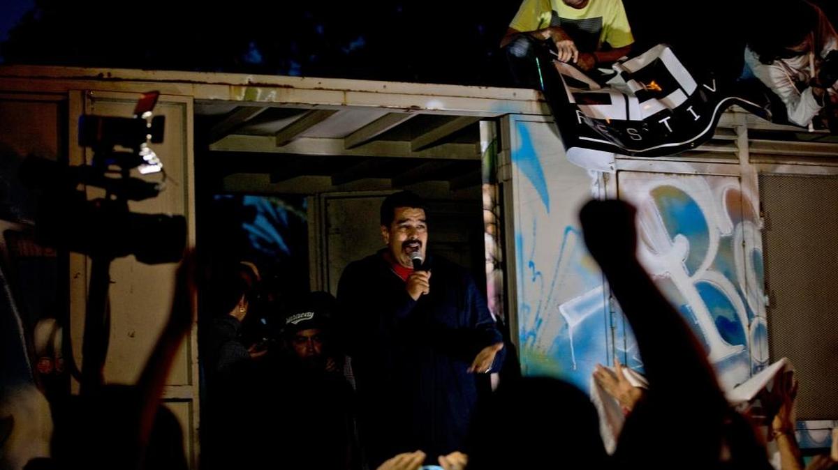 Venezuela's President Nicolas Maduro speaks to supporters from a truck outside of Miraflores Presidential palace in Caracas, Venezuela, Wednesday, Dec. 9, 2015. Maduro is promising to protect the country’s socialist revolution from what he says are “bad guy” opposition leaders who will take control of Congress next month.