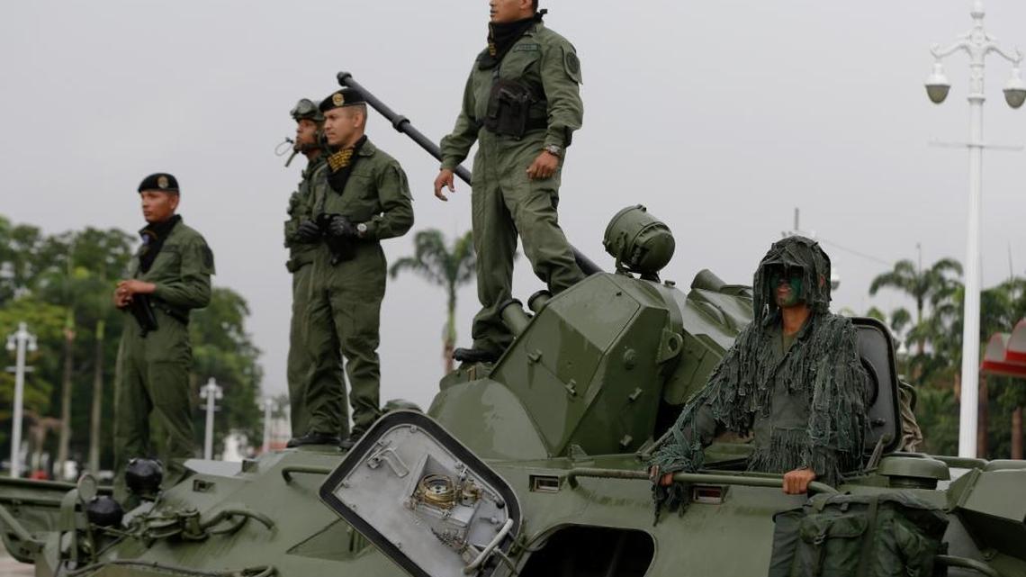 In this file photo, soldiers stand atop an armored vehicle at the entrance of Fort Tiuna in Caracas, Venezuela, in 2017.