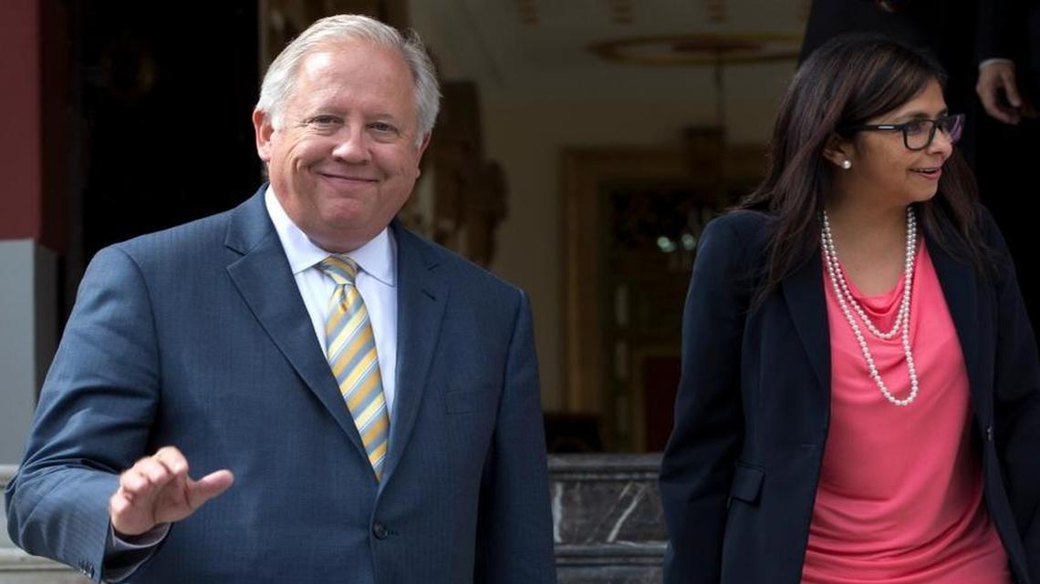 U.S. diplomat Thomas Shannon, left, smiles towards the press as he walks with Venezuela's Foreign Minister Delcy Rodriguez, after a private meeting with President Nicolas Maduro at Miraflores Presidential Palace in Caracas, Venezuela, Wednesday, June 22, 2016. Shannon, the U.S. undersecretary of state for political affairs, met with Maduro during a visit meant to help jumpstart dialogue with the South American nation that faces mounting political strife and economic hardship.