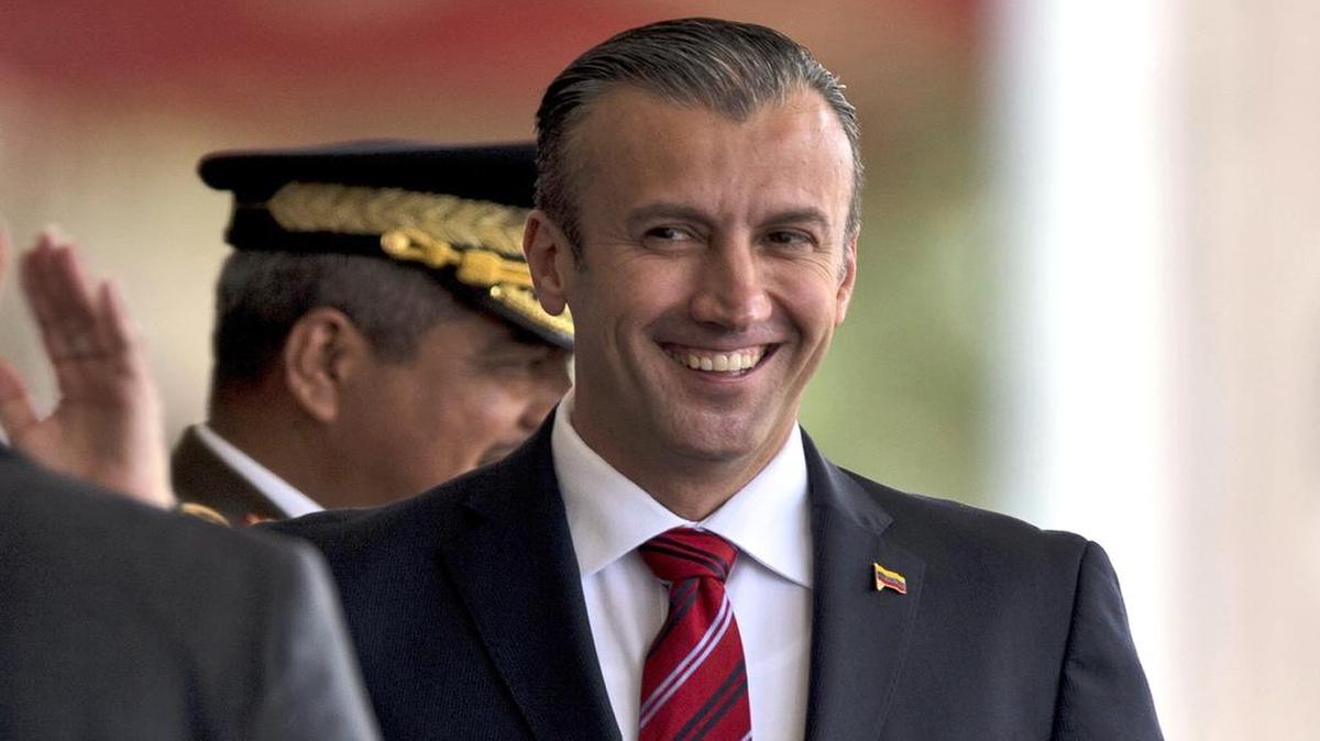 In this Feb. 1, 2017 photo, Venezuela's Vice President Tareck El Aissami, right, is saluted by Bolivarian Army officer upon his arrival for a military parade at Fort Tiuna in Caracas, Venezuela. The administration of President Donald Trump is slapping sanctions on El Aissami and accusing him of playing a major role in international drug trafficking.