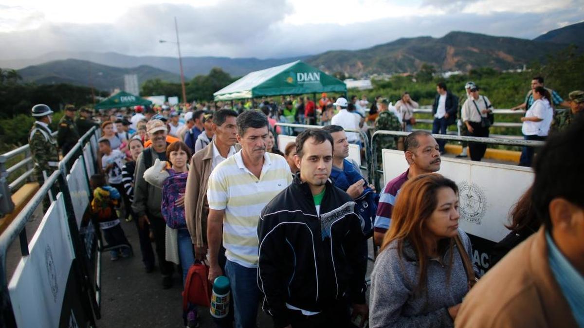 Venezuelans cross Simon Bolivar bridge from San Antonio del Tachira, Venezuela to Cucuta, Colombia, Sunday, July 17, 2016, during a temporary opening of the long-closed border. More than 100,000 Venezuelans crossed what Colombian officials are calling a "humanitarian corridor" to buy as many basic goods as possible.