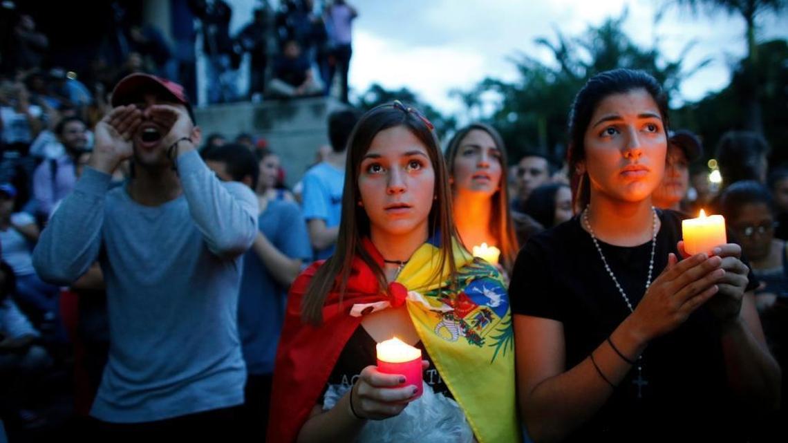 Anti-government demonstrators hold candles during a vigil Monday in honor of those who have been killed during clashes between security forces and demonstrators in Caracas.