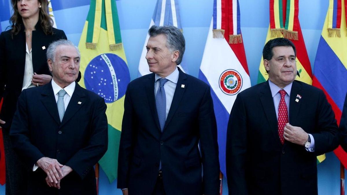 Brazil's President Michel Temer, from left, Argentina's President Mauricio Macri and Paraguay's President Horacio Cartes, pose for a picture at the Mercosur Summit in Mendoza, Argentina, Friday, July 21, 2017.