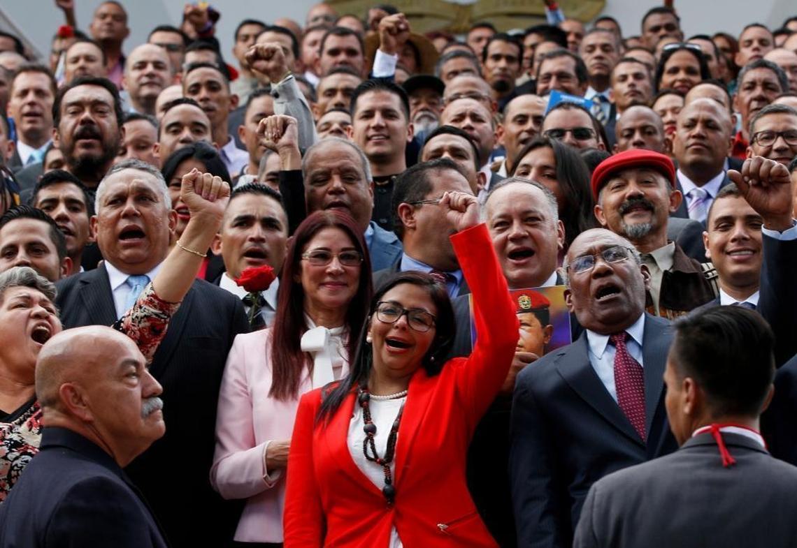 Constituent Assembly President Delcy Rodríguez, front and center, leads newly sworn-in delegates as they pose for an official portrait Friday.