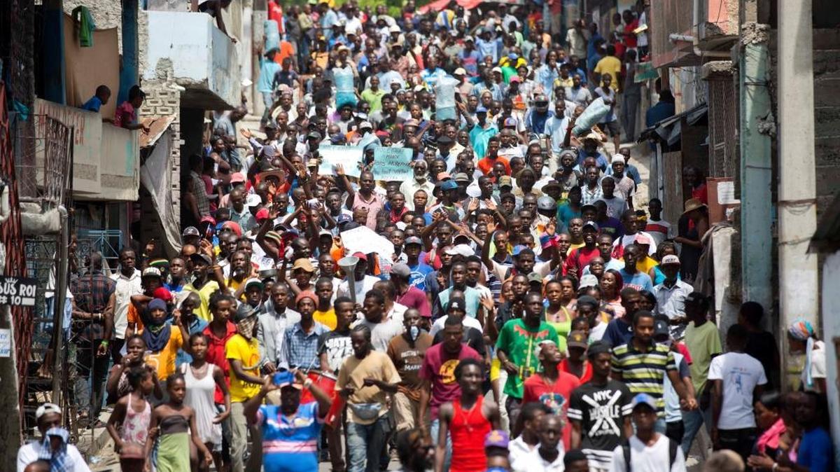 Demonstrators march during a protest against government tax hikes in Port-au-Prince, Haiti, Thursday Sept. 28, 2017. In early September, lawmakers approved a budget that will raise taxes on products including cigarettes, alcohol and licenses.