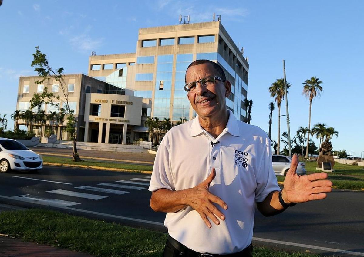 Bernardo Marquez, mayor of Toa Baja, talks in front of the government building that closed down due to damage by Hurricane Maria.