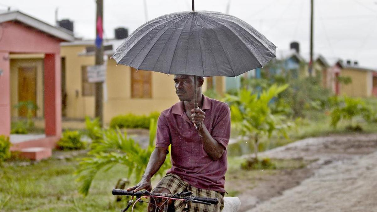 A man rides his bike through the Caracol-EKAM housing development built by the U.S. Agency for International Development.