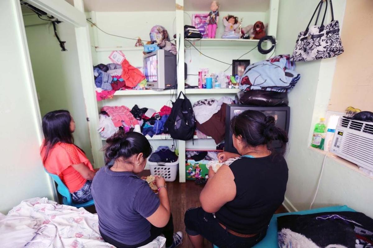 Guatemalan migrant Manuela (right) with her daughter and sister, both minors, at their apartment in Palm Beach County. She has paid exorbitant fees to get to her appointments with the immigration authorities.