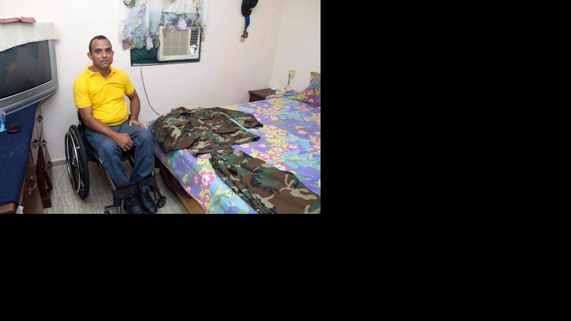 
Wilkin Cuello Gonzalez poses with his Army uniform at his home in Santo Domingo. He was among 600 Dominican soldiers who served in the Iraq War as part of the Coalition of the Willing. They became the first generation of Dominican soldiers to be deployed to war abroad. 
