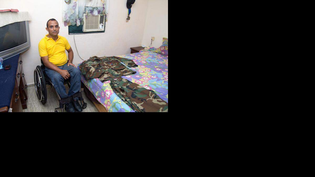 
Wilkin Cuello Gonzalez poses with his Army uniform at his home in Santo Domingo. He was among 600 Dominican soldiers who served in the Iraq War as part of the Coalition of the Willing. They became the first generation of Dominican soldiers to be deployed to war abroad. 
