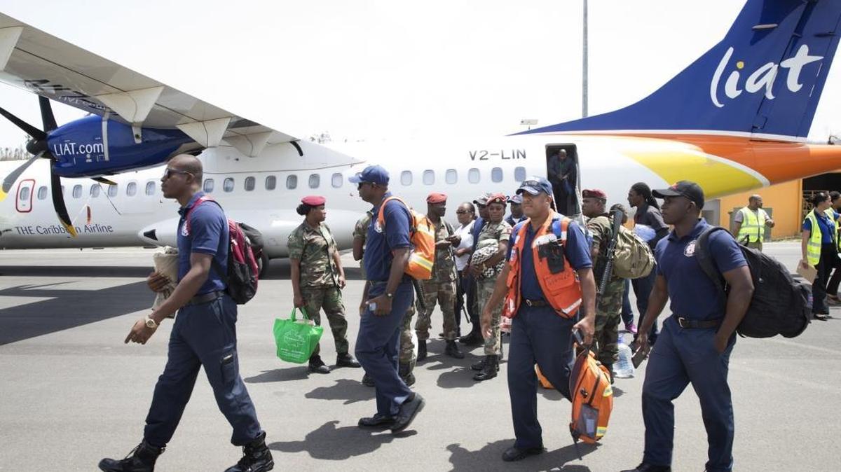 Firemen and military personal from Antigua arrive on September 23, 2017 at the Douglas Charles Airport in Dominica. Rescue efforts continue after Hurricane Maria inflicted catastrophic damages with at least 15 deaths in this Caribbean island.