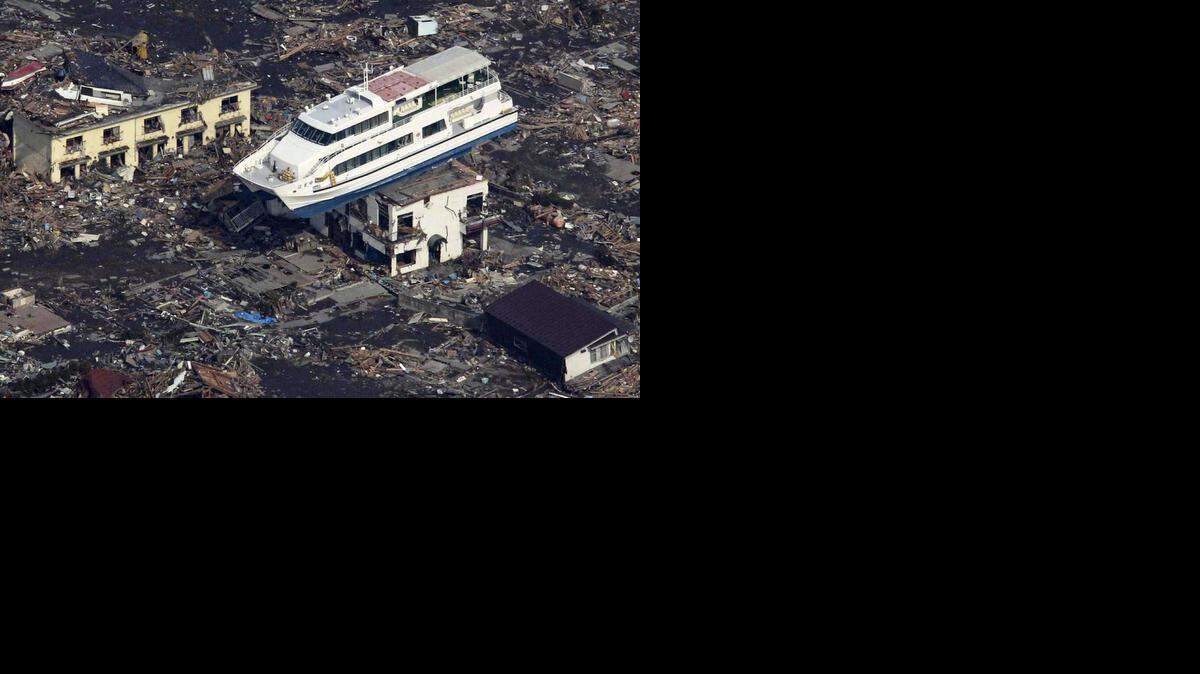 
This file aerial shot shows a pleasure boat sitting on top of a building amid a sea of debris in Otsuchi town in Iwate prefecture on March 14, 2011 following the March 11 tsunami. A nuclear power plant damaged by An explosion also rocked the earthquake-hit Fukushima nuclear plant.


