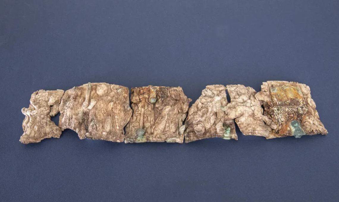 The ancient ivory fragments arranged in a row.