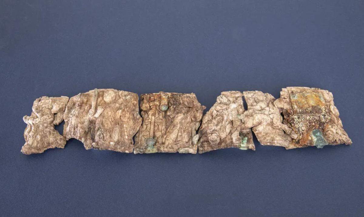 The ancient ivory fragments arranged in a row.