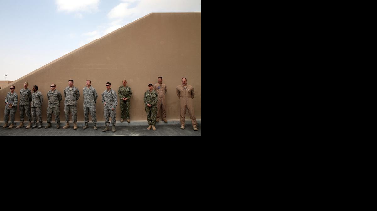 
In this Dec. 10, 2013, photo, U.S. troops listen to Secretary of Defense Chuck Hagel as he speaks at the al Udeid air base in Qatar. 
