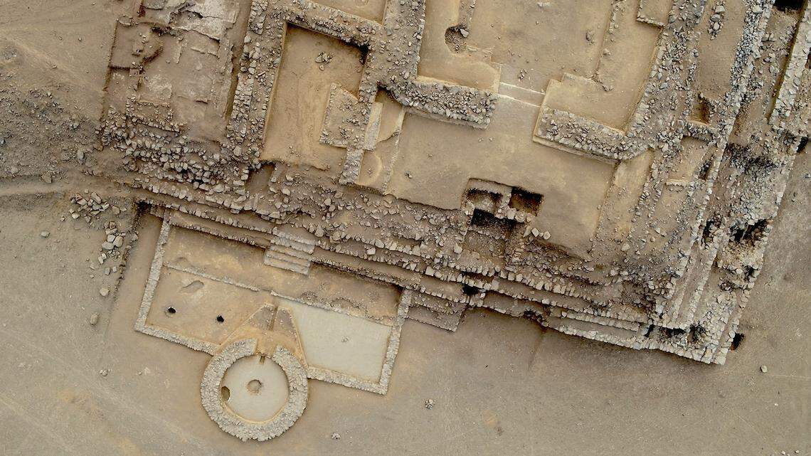 An aerial view shows the ancient fire altar (bottom left), surrounding courtyard and nearby pyramid.
