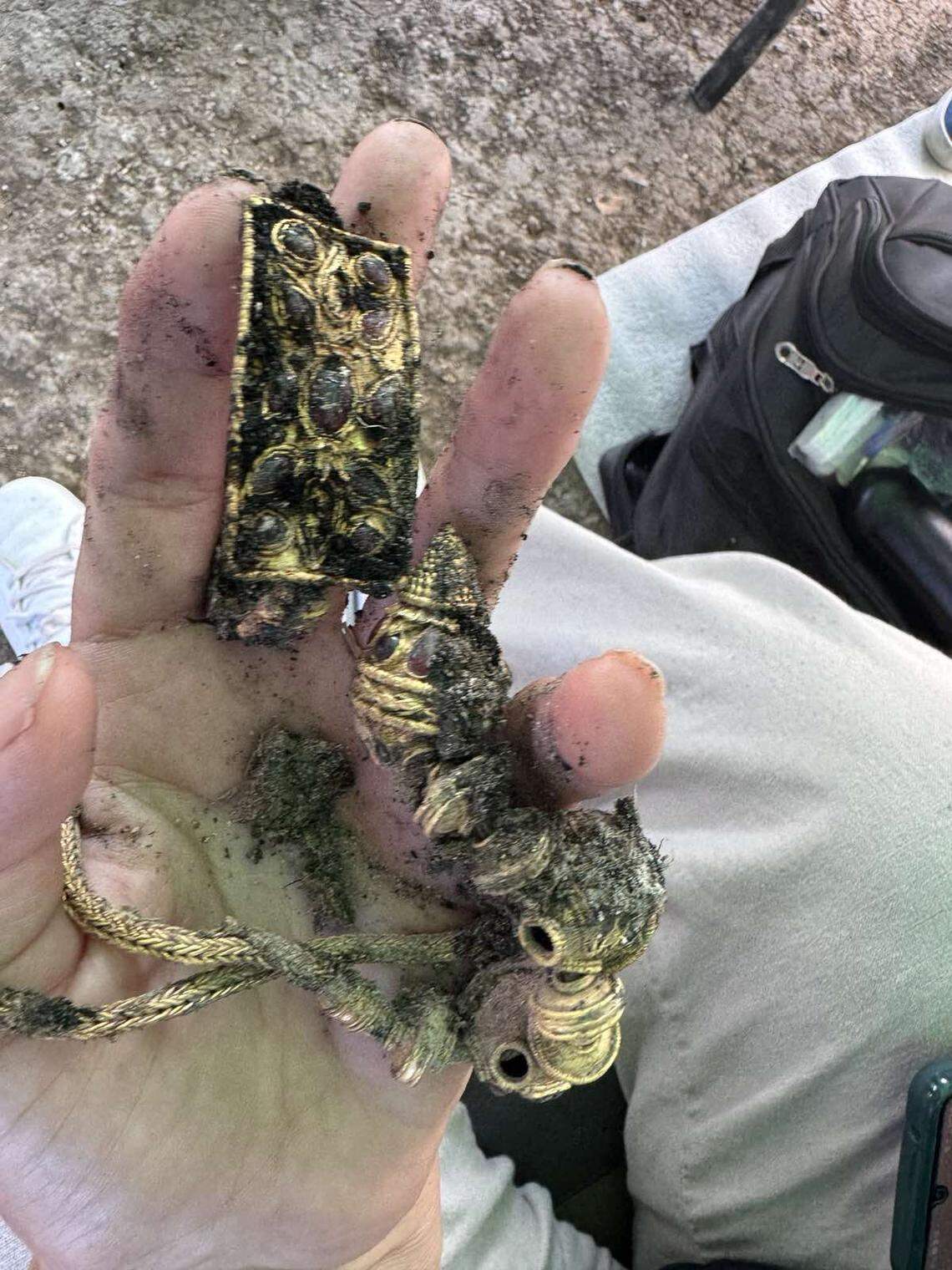 A gold bracelet and necklace with matching designs found in the grave.