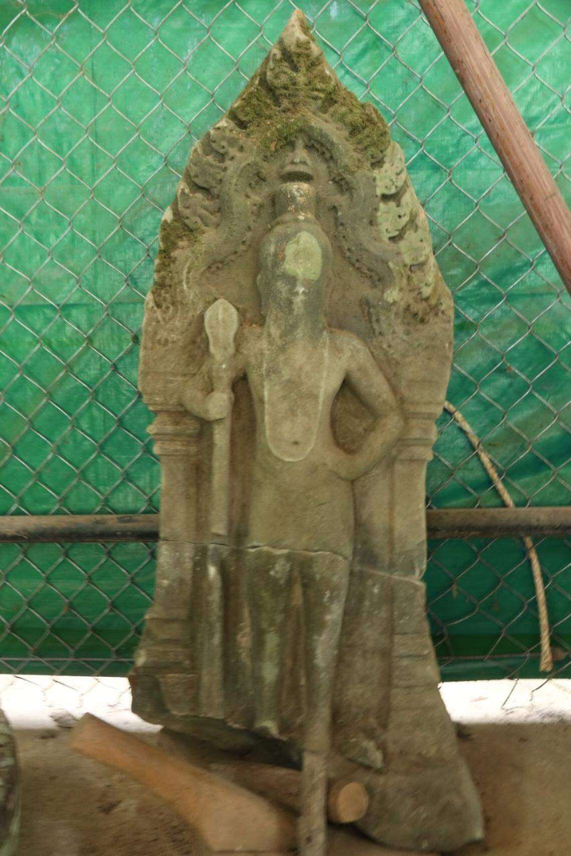 A worn 900-year-old statue found near the palace gate.