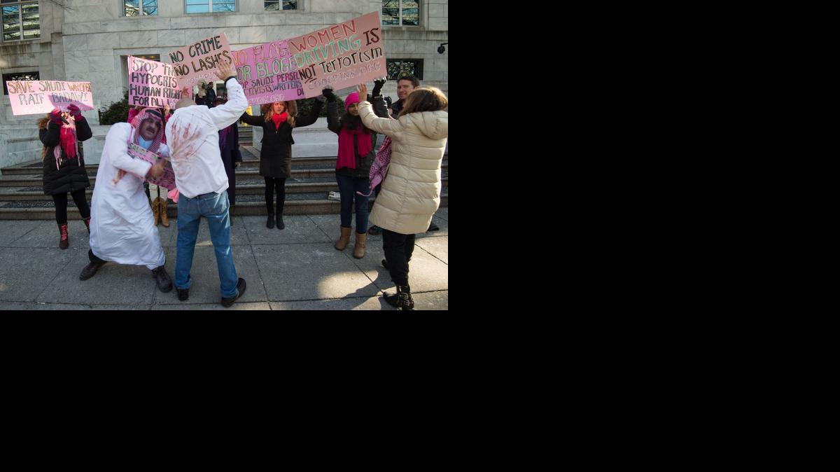 
Protesters simulate a flogging in front of the Saudi embassy in Washington, D.C. on Jan. 15, 2015 during a demonstration against the 10-year prison sentence and 1,000 lashes of Saudi activist Raef Badawi for “insulting Islam” in a blogpost. The 31-year-old received a first installment of 50 lashes on Jan. 9, 2015 and is expected to have 20 weekly whipping sessions until his punishment is complete. 
