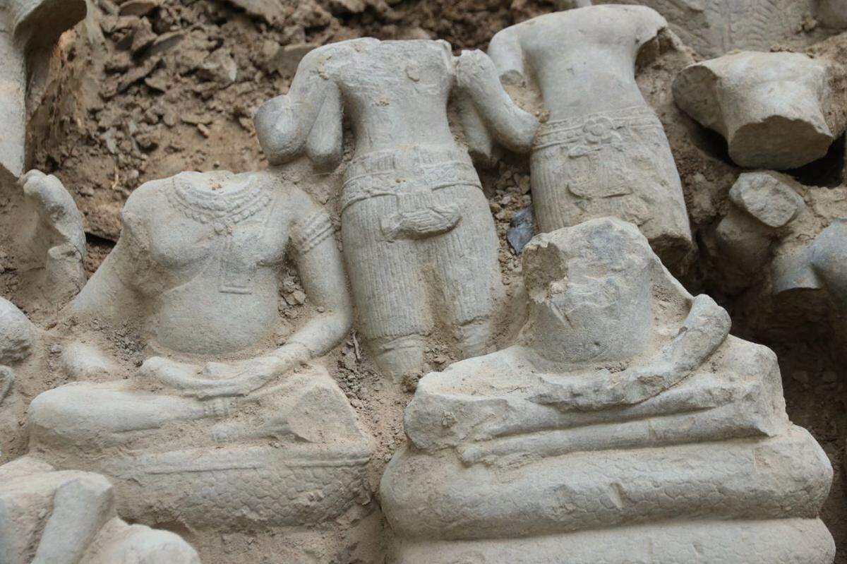 A close-up photo shows some of the statues.