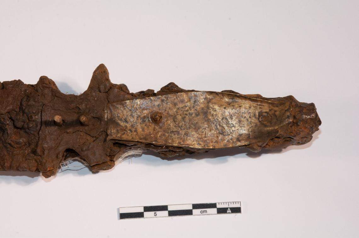 A close-up photo shows the hilt of the 1,000-year-old sword.