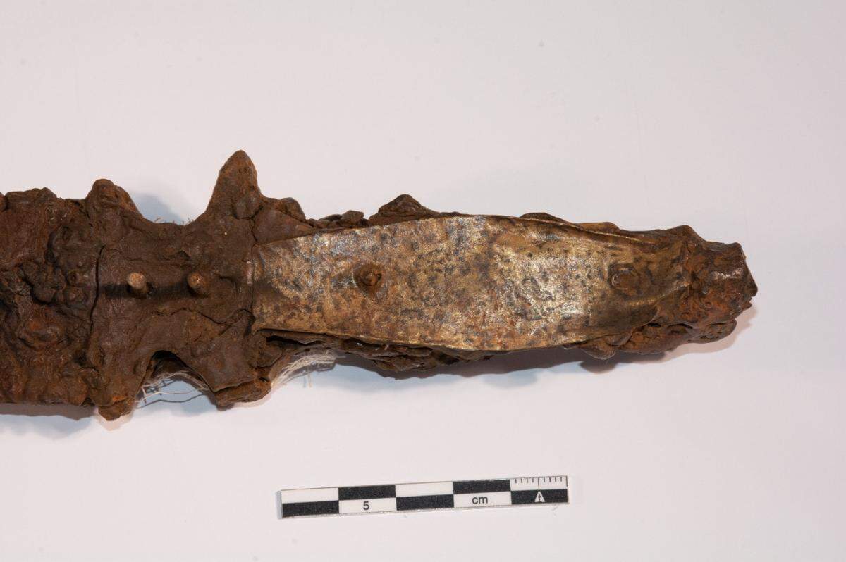 A close-up photo shows the hilt of the 1,000-year-old sword.