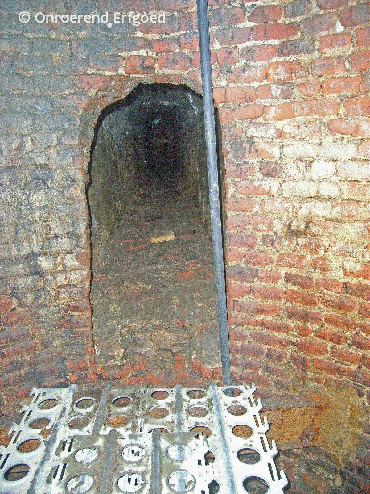 A view from the bottom of the vertical shaft looking across the well to the tunnel.