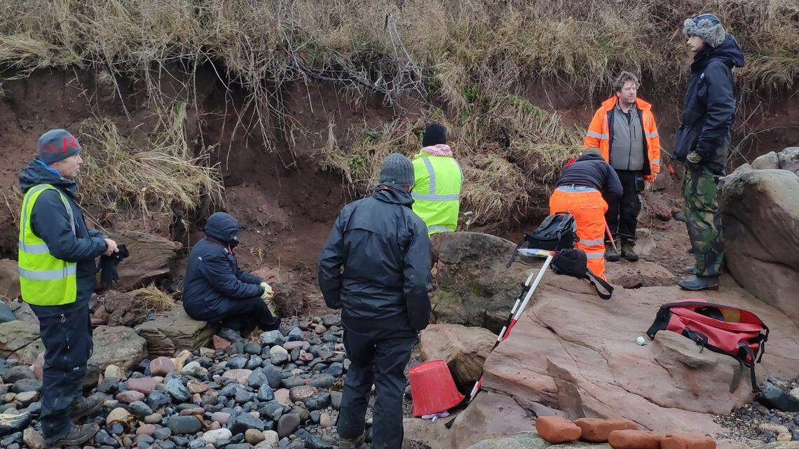 After a storm, archaeologists found a skull and bones sticking out of the sand near Wemyss Caves, leading them to a pair of 1,000-year-old burials, photo show.
