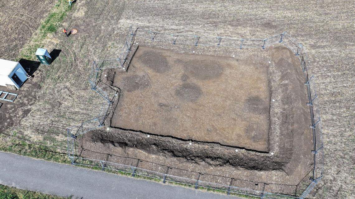 Several ancient storage pits, marked by their discolored soil, as seen during excavations.