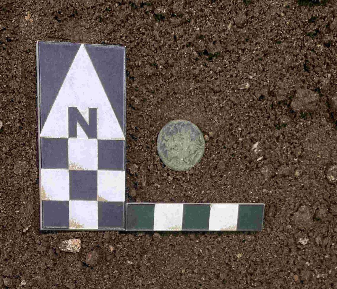 An ancient Roman coin found in the secondary looted tomb in Manduria, Italy.