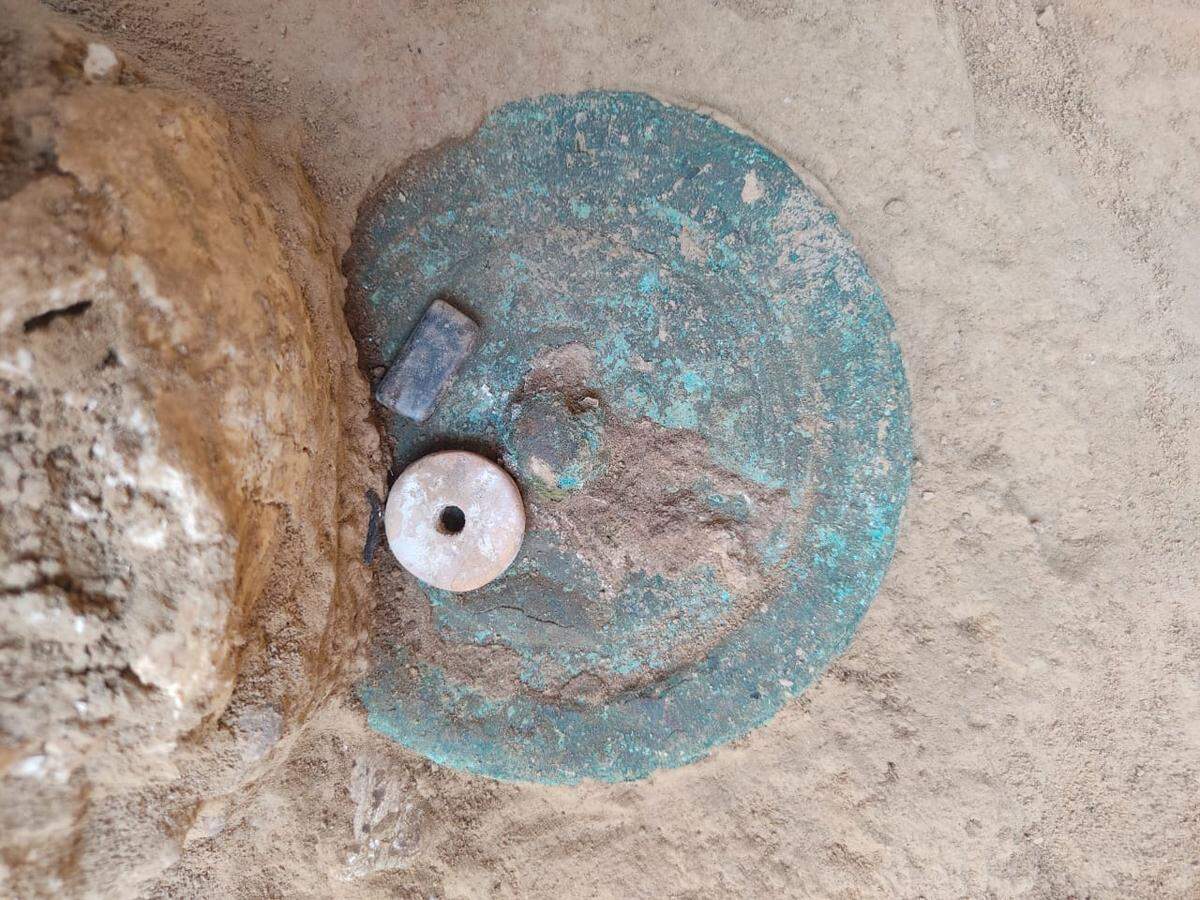 The bronze mirror found in the 1,600-year-old burial.