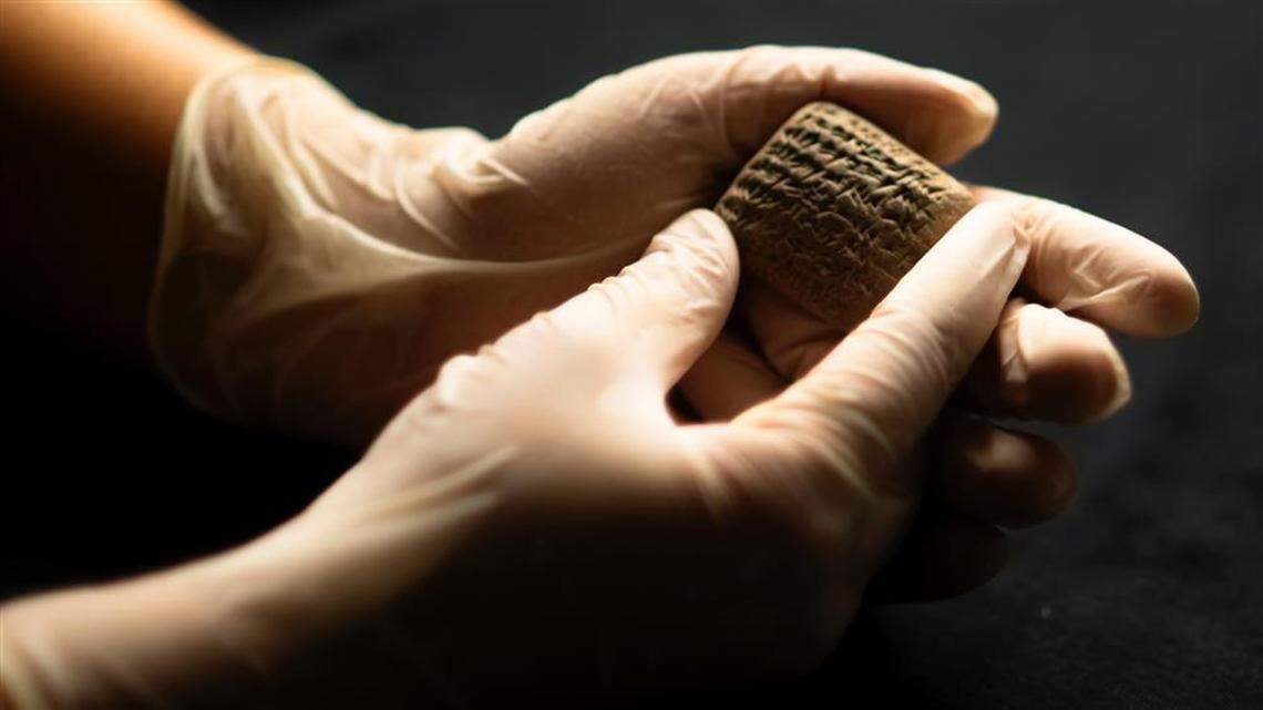 An archaeologist holds the 3,400-year-old sales receipt.