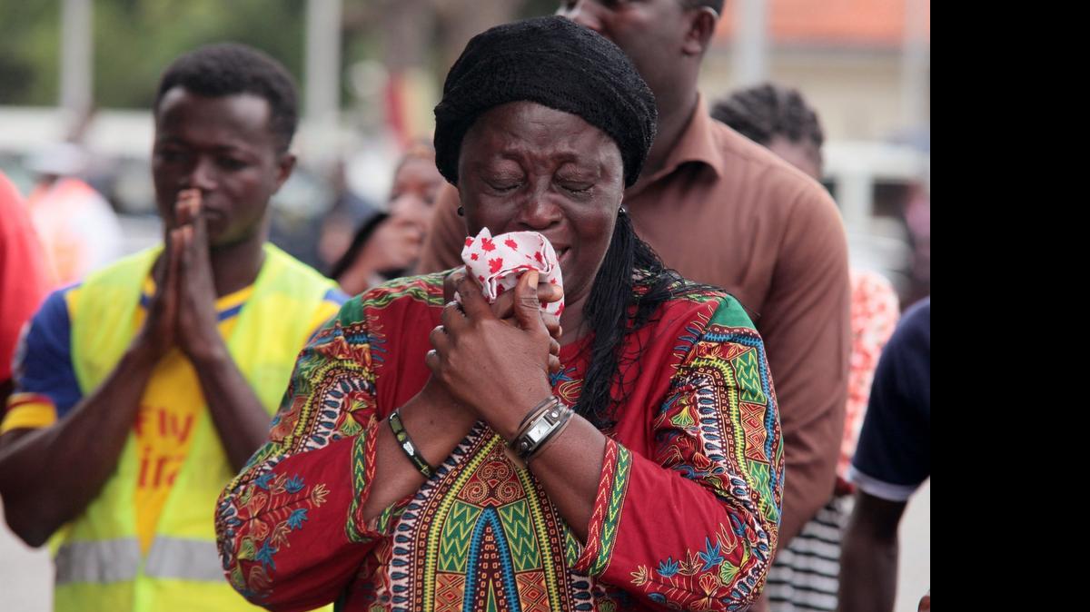 
Family members of a person who died react at a national service for victim's of a gas station that ignited killing around hundred and sixty people last week, in Accra, Ghana, Wednesday, June 10, 2015. The flooding in the capital last week caused fuel from a gas station to ignite, killing at least 160 people. As the country mourned the victims at a national service Wednesday, the Ghanaian government is facing allegations that poorly managed city planning contributed to the tragedy. 

