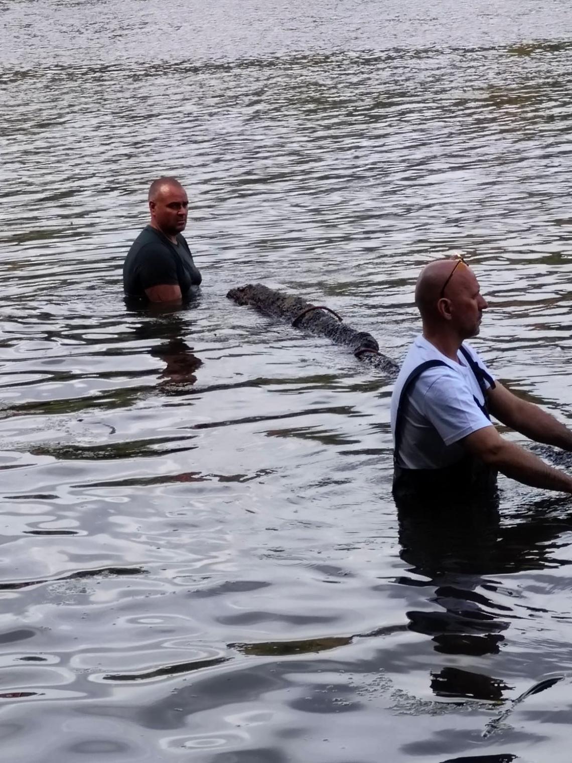 A close-up photo shows the group bringing the historic canoe to the surface.