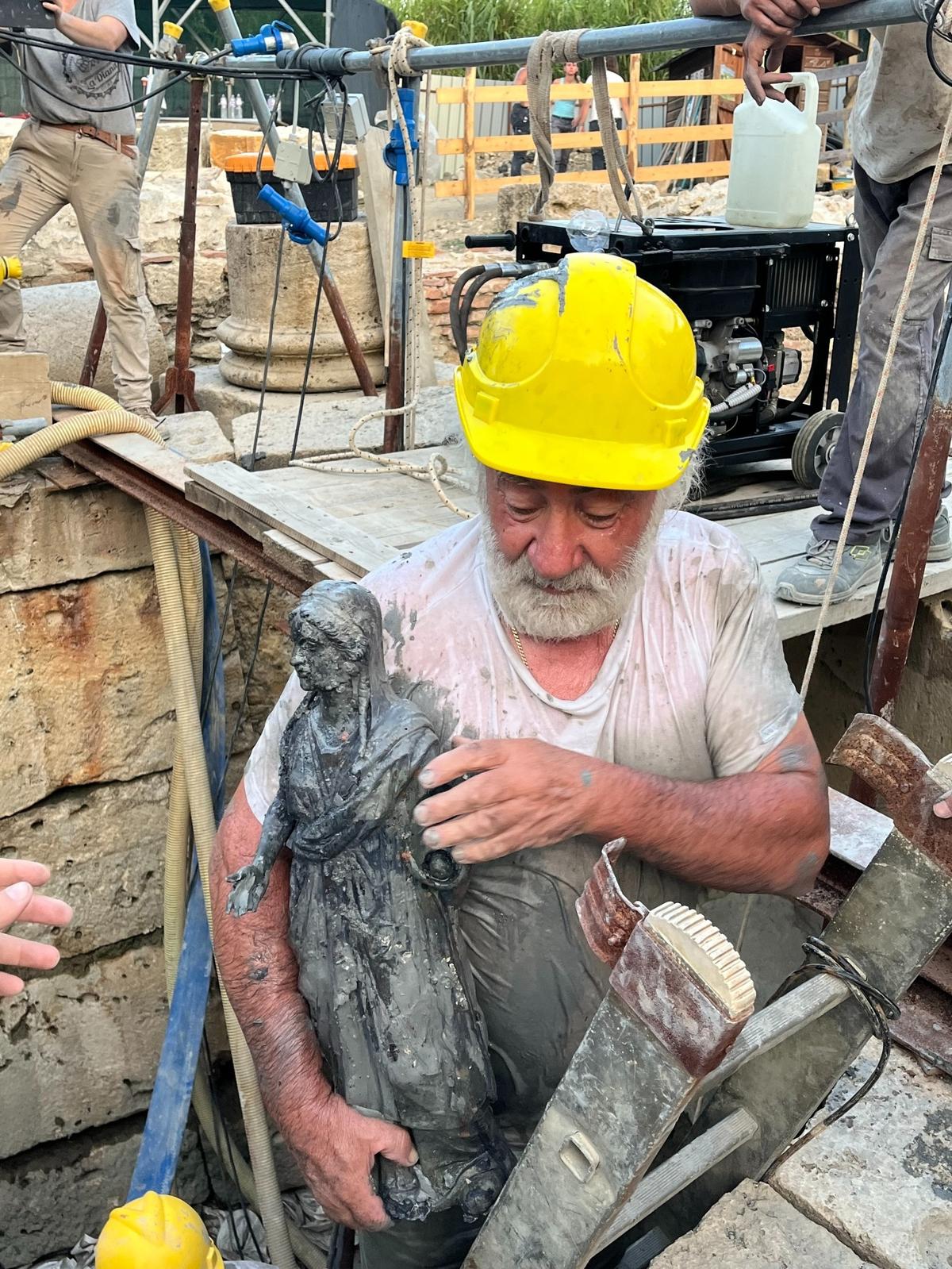 One of the bronze statues being removed from the spring.