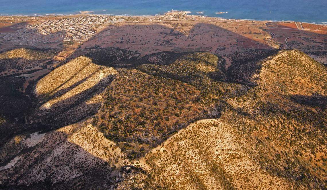 An aerial view of Ptolemais with the coast visible in the distance.