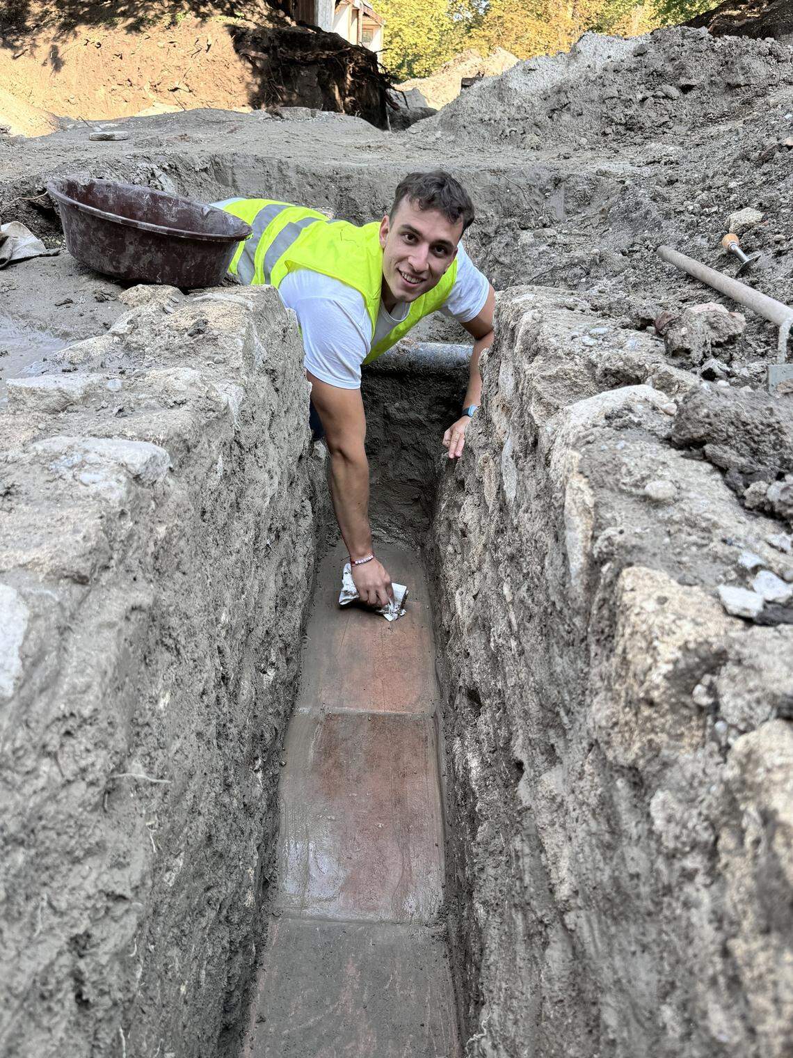 A student archaeologist helps excavate the ancient Roman aqueduct.