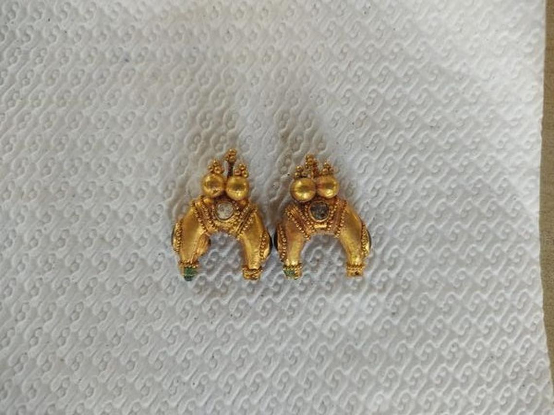 Two gold earrings found in the 1,600-year-old grave.