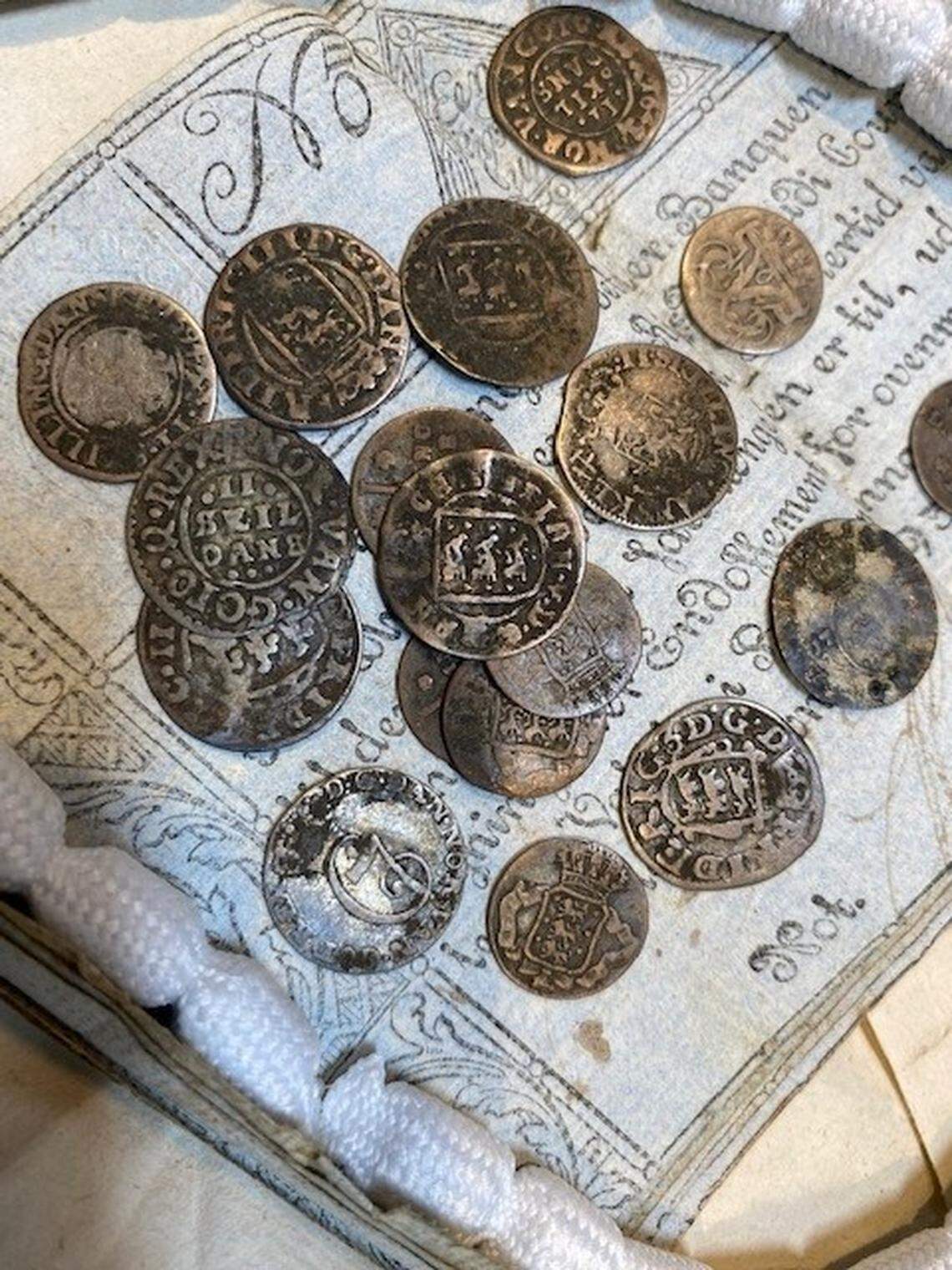Some of the silver coins, identified as Danish skillings, in a package from 1807.