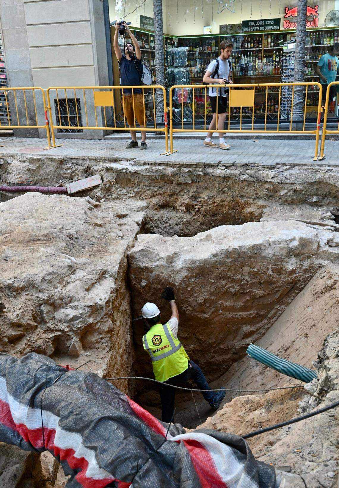An archaeologists excavates the 600-year-old walls in Barcelona’s Plaça del Teatre.