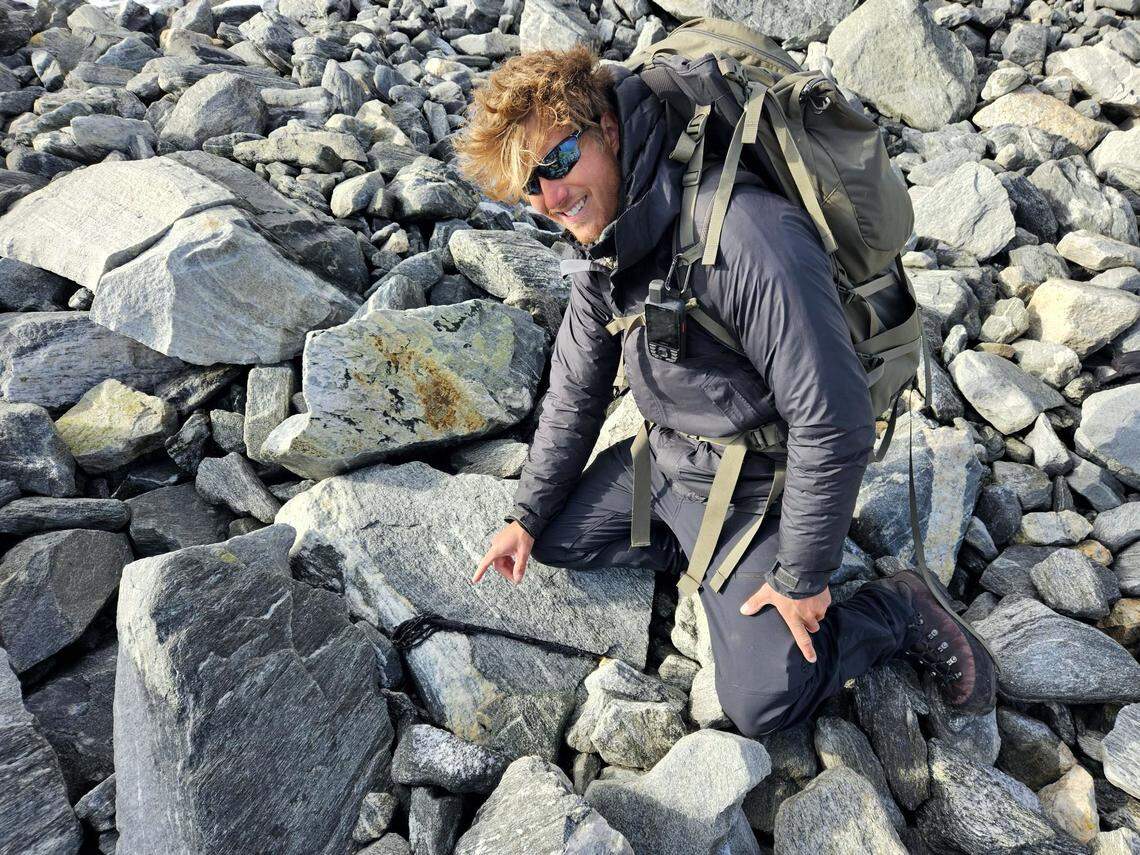 Archaeologist Andreas points at the ancient scaring stick.