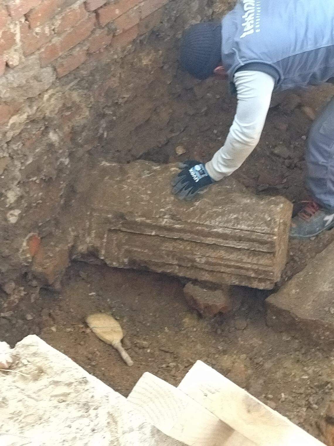 A worker moves some of the medieval building ruins found under Čazma City Museum and Cultural Center.