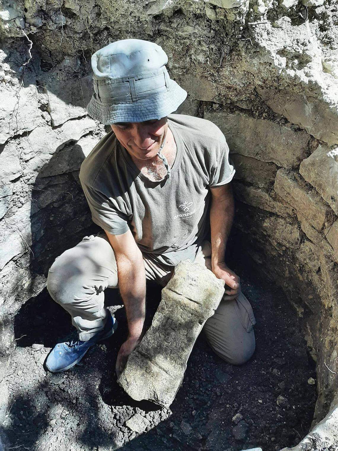 An archaeologist holds the 1,900-year-old altar.