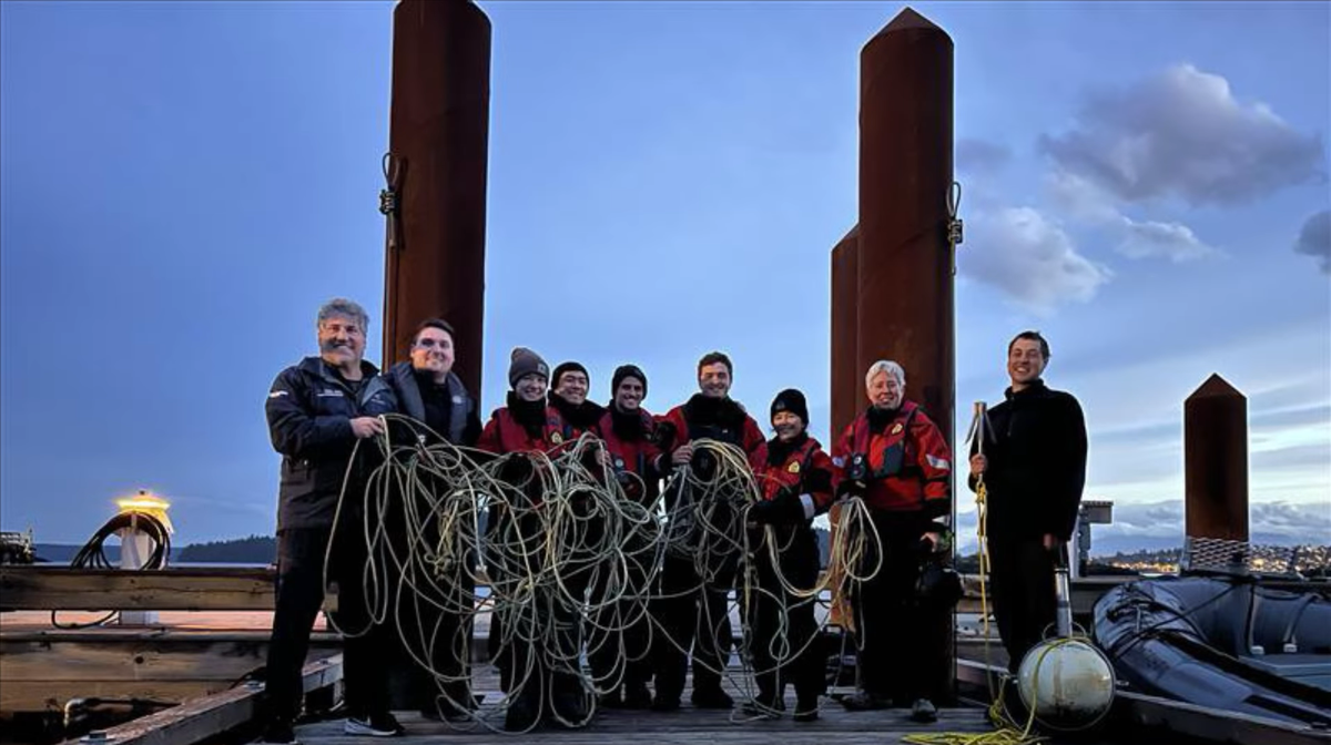 Trainees with the fishery department hold the rope they removed from the humpback whale.