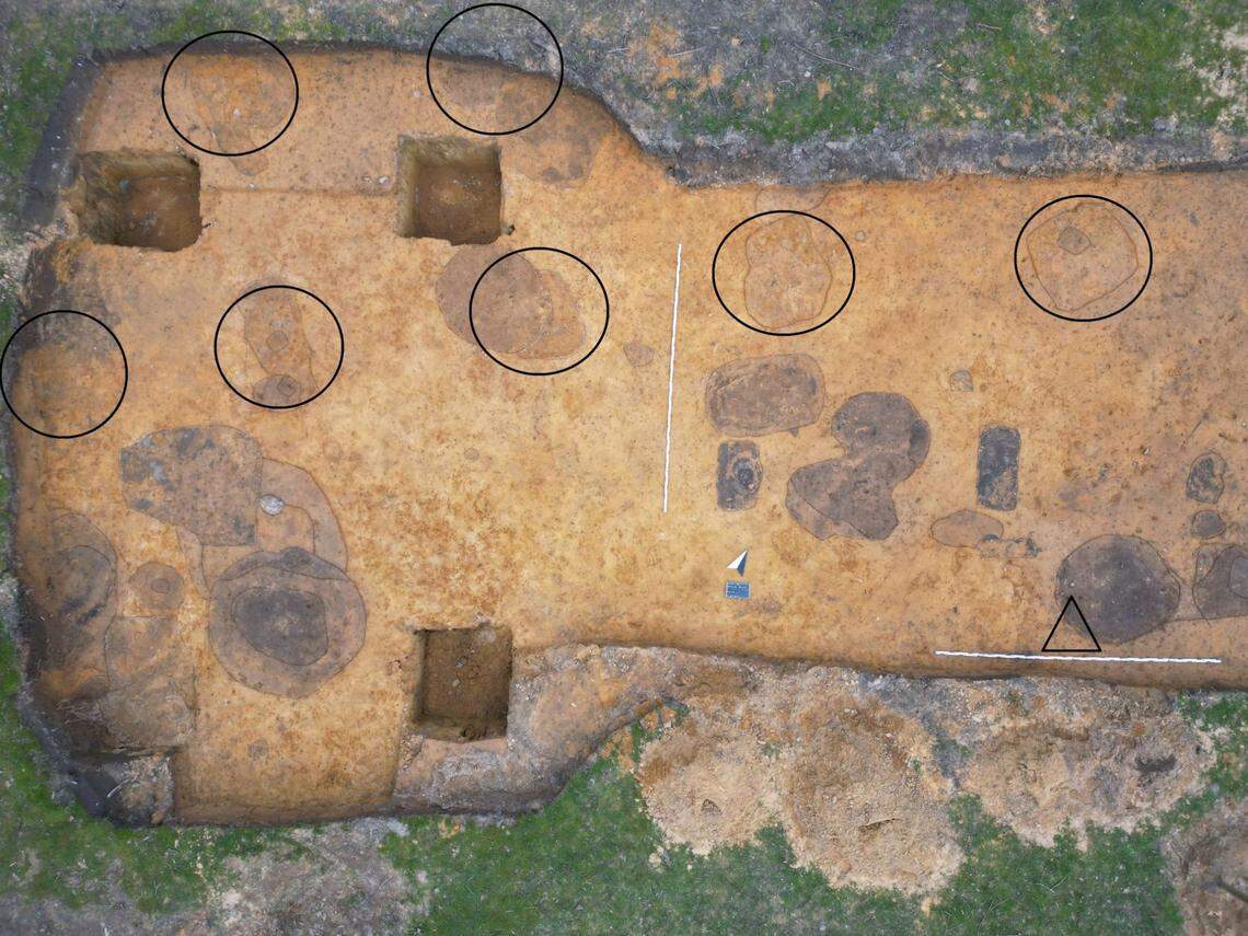 An aerial photo shows where the ancient Roman shoe (marked with a triangle) and wall traces (marked with circles) were found.