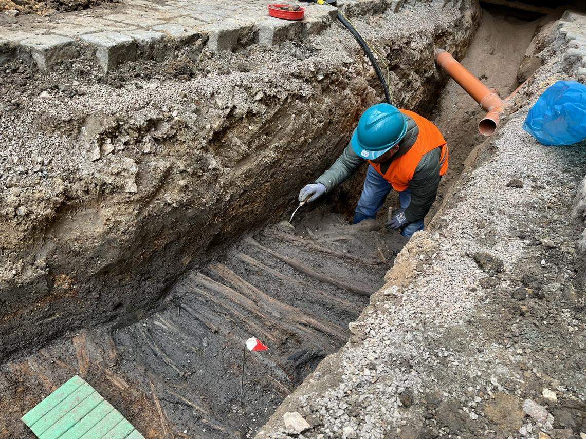 An archaeologist excavates the medieval street found in Pardubice.