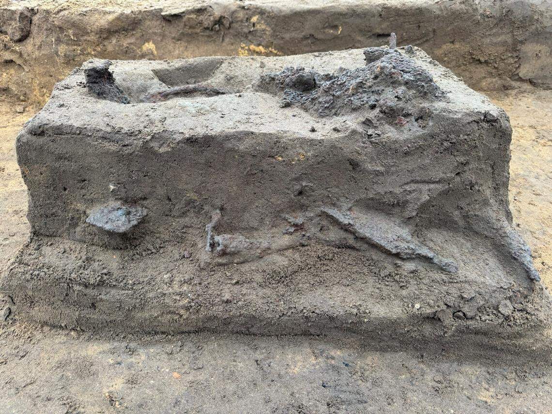 The rare chainmail shirt and nearby weapons as seen midway through excavations.